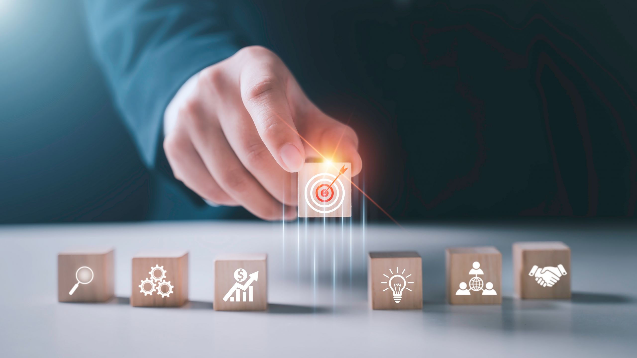 businessman arranging a series of small wood blocks