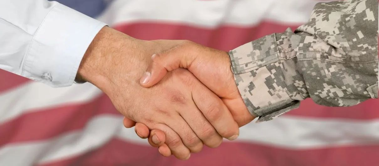 decorative banner image of two hands shaking in front of an american flag